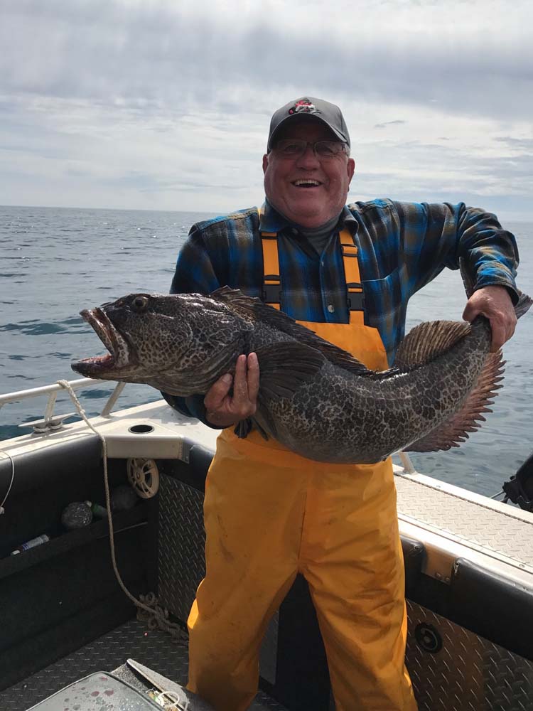 Fisherman with huge lingcod catch